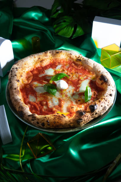 istock Neapolitan pizza on green fabric with geometric shapes 1457021246