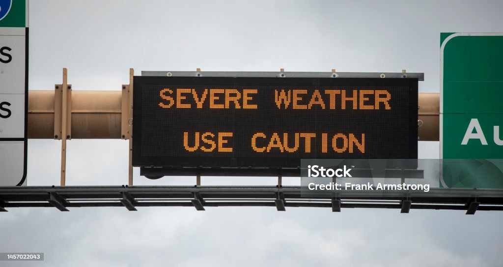 Digital sign at freeway stating Severe Weather Use Caution with wet freeway and traffic. Digital sign at freeway stating Severe Weather Use Caution with wet freeway and traffic. The image is from the 15 freeway in San Diego County California Accidents and Disasters Stock Photo
