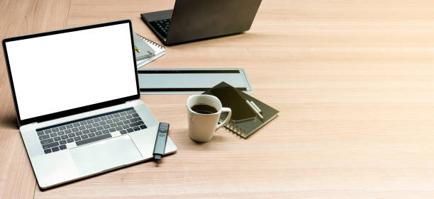 White display laptop with coffee cup on table in meeting room