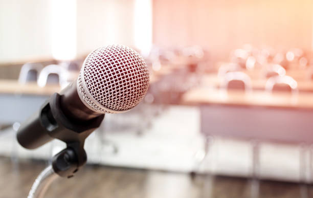 istock Microphone on abstract blurred of speech in seminar room 1457022674