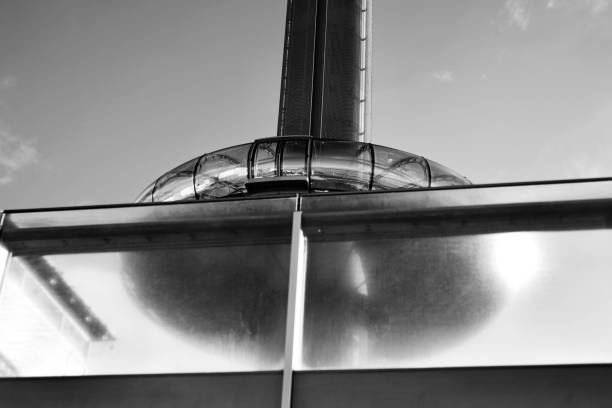 Up view of abandoned dismantled cooling tower with a cloudy sky, in monochrome.