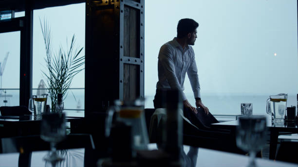 istock Handsome businessman enjoying beautiful ocean view in panoramic restaurant hall 1457023222