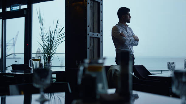 istock Focused entrepreneur silhouette resting cozy panoramic lounge restaurant alone 1457023345