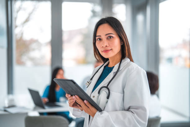 istock Professional Asian Female Dermatologist Holding A Digital Tablet 1457023641