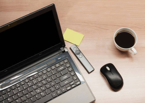 istock Top view laptop and coffee and accessories on table 1457024883