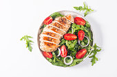 Salad with grilled chicken fillet meat, fresh vegetables, spinach, ruccola, red onion and tomato. Healthy menu. Diet food. Top view. Banner