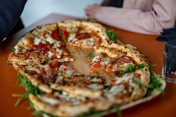 istock Delicious Different Pizza Slices On A Palm Leaf 1457031946