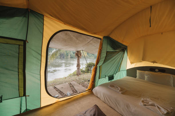 istock Inside of large comfortable camping tent on campground in the tropical forest by riverside on vacation 1457032097