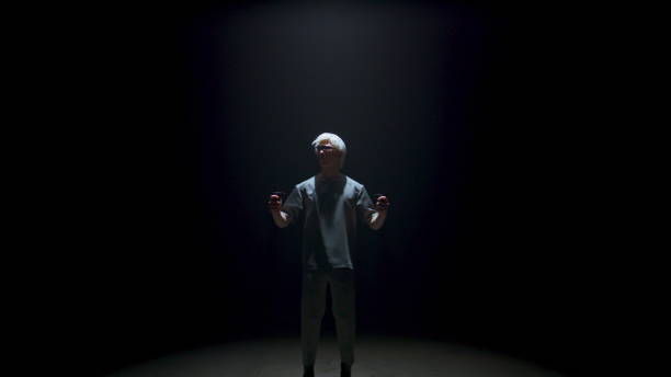 istock Guy using virtual reality controllers headset in dark room. Futuristic man play 1457034185