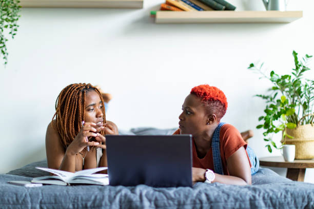 black female students learning from home using laptop - braids african descent women pensive imagens e fotografias de stock