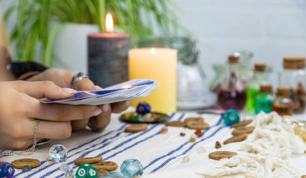 A fortune teller reads with tarot cards. Selective focus. A fortune teller reads with tarot cards. Selective focus. Woman. tarragon horizontal color image photography stock pictures, royalty-free photos & images