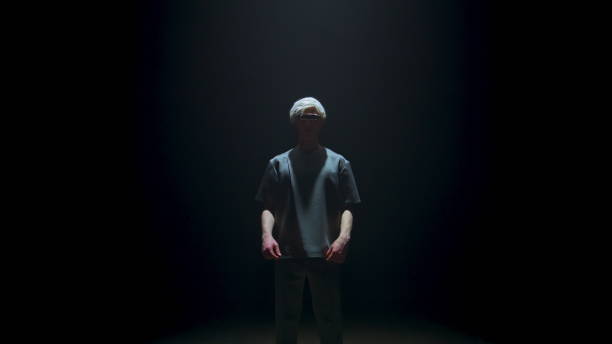 istock Man starting vr headset in dark room. Metaverse player touching goggles prepare 1457035562
