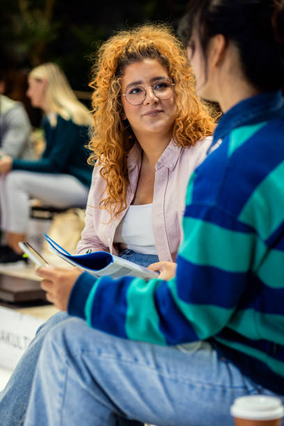 istock Diverse group of student siting in campus learning together. 1457037372