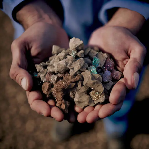 Male human hands holding Rare Earth Elements. Mining and Prospecting.