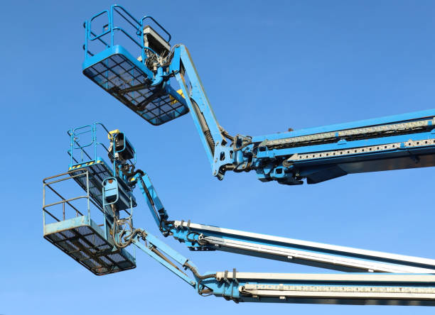 istock Three blue hydraulic working platforms  of cherry picker. 1457039081