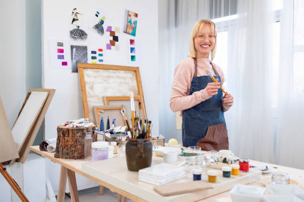 istock Young female artist is in her painting studio 1457039095