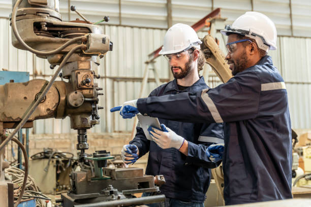 istock Team of engineers practicing maintenance Taking care and practicing maintenance of old machines in the factory so that they can be used continuously. 1457040691