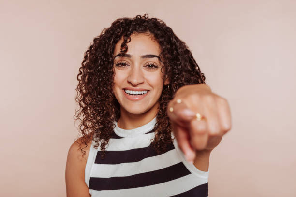 istock Cheerful brunette arabic woman pointing finger at camera 1457040784