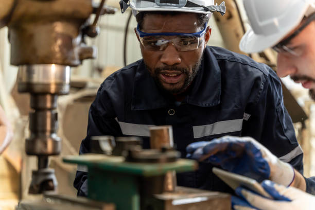 istock Team of engineers practicing maintenance Taking care and practicing maintenance of old machines in the factory so that they can be used continuously. 1457040942