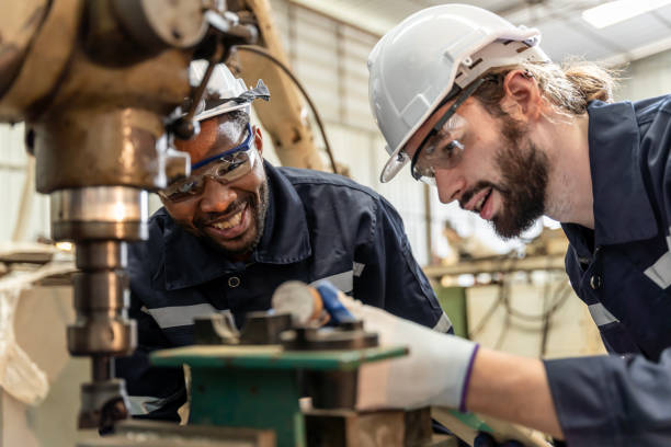 istock Team of engineers practicing maintenance Taking care and practicing maintenance of old machines in the factory so that they can be used continuously. 1457040972