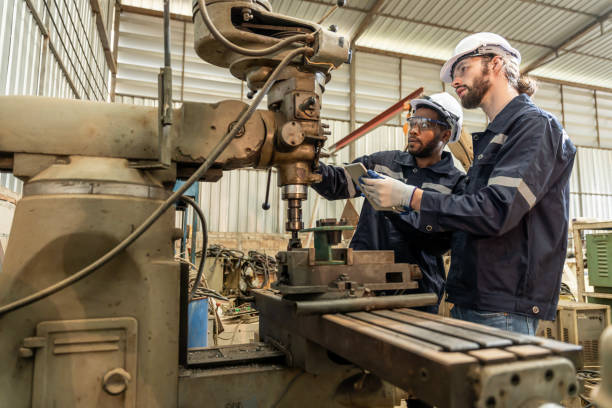 istock Team of engineers practicing maintenance Taking care and practicing maintenance of old machines in the factory so that they can be used continuously. 1457041070