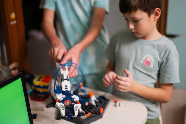 istock Children learning repairing getting lesson control robot arm, robotic machine arm in home workshop, technology future science education. 1457043196