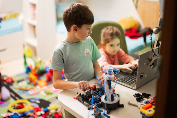 istock Children learning repairing getting lesson control robot arm, robotic machine arm in home workshop, technology future science education. 1457043198
