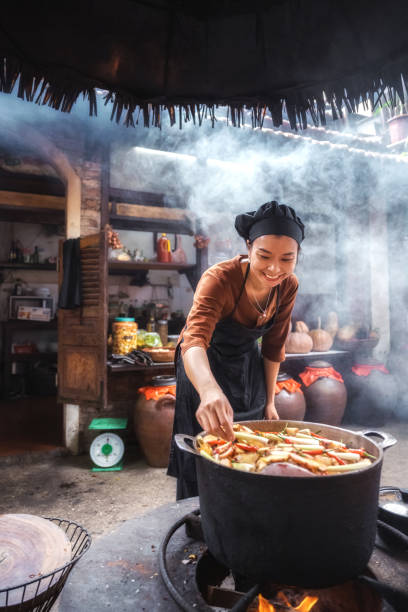 istock young vietnamese female chef cooking on open fire in restaurant 1457043909