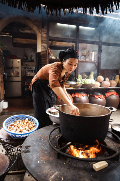 istock young vietnamese female chef cooking on open fire in restaurant 1457044134