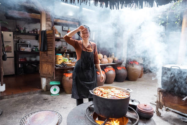 istock young smiling vietnamese female chef cooking in open kitchen in restaurant 1457044228
