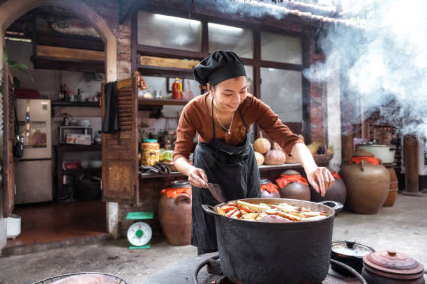 istock young vietnamese female chef cooking on open fire in steaming kitchen 1457044498