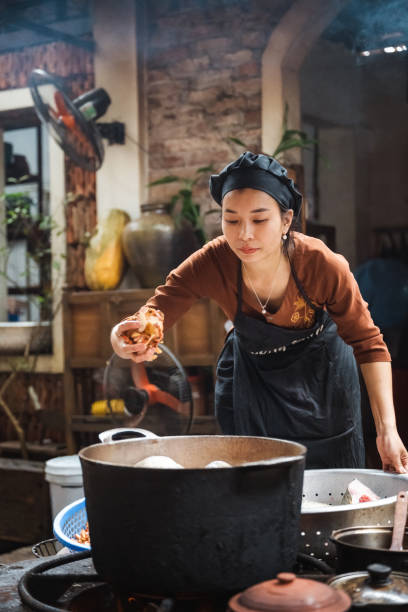 istock young vietnamese female chef cooking on open fire in restaurant 1457045423