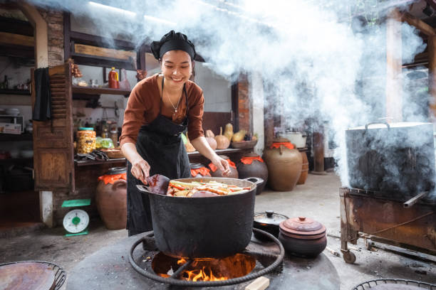 istock young smiling vietnamese female chef cooking on open fire in restaurant 1457045619