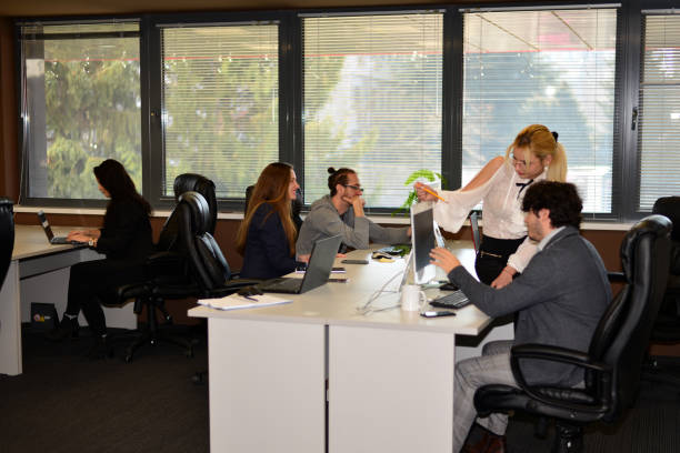 Young, smiling and motivated employees at work in the office.