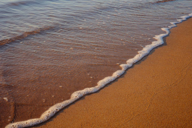istock Waves on the beach, Sand on the beach with a sea wave. 1457051607