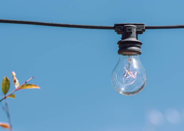 istock Low angle view of light bulb against clear blue sky 1457053642