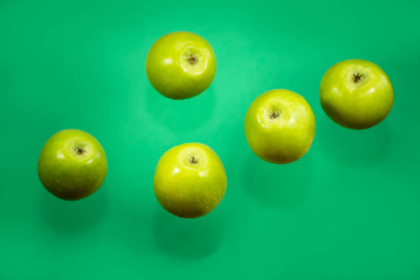 istock green whole apple on green background 1457053991