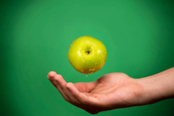 green whole apple on green background