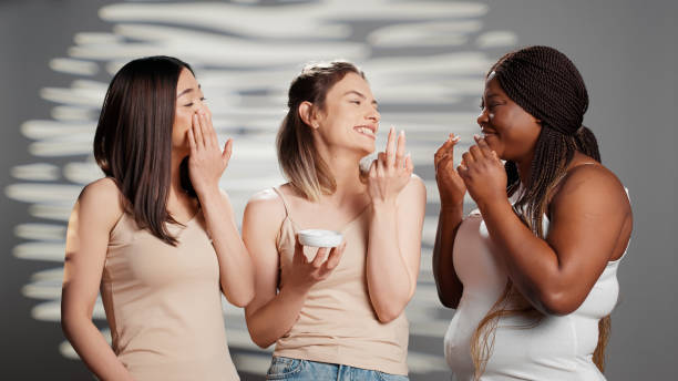 istock Group of beautiful girls applying moisturizing cream 1457054229