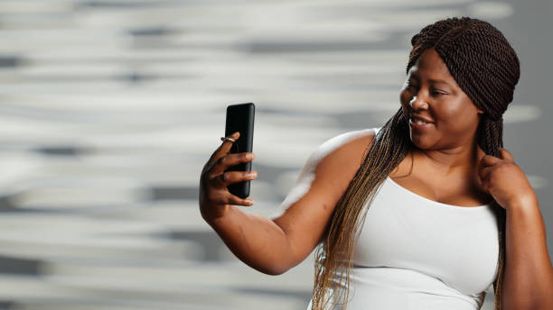 istock African american woman posing on smartphone camera 1457055873