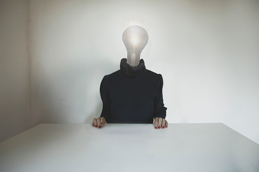 surreal business people with a light bulb affixed to the head, concept of idea, innovation, business, creativity, energy; efficiency