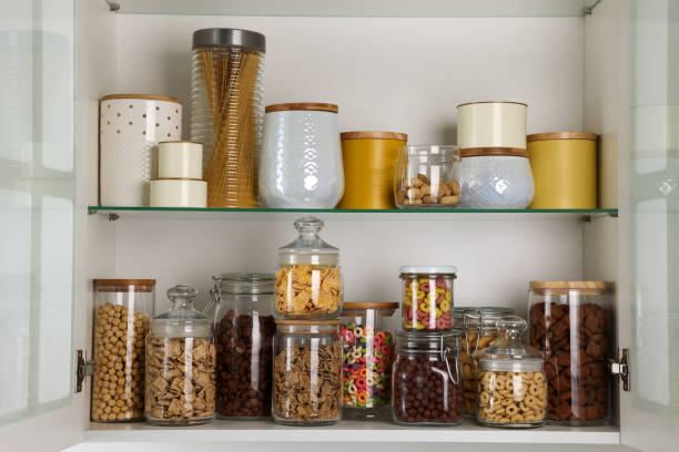 istock Glass containers with different breakfast cereals and other products on shelves 1457057695