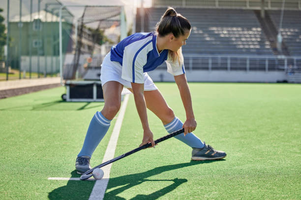 Sports, hockey and woman in action on field with hockey stick ready to hit ball in game. Fitness, exercise and female athlete playing field hockey in outdoor stadium for workout, training and health Sports, hockey and woman in action on field with hockey stick ready to hit ball in game. Fitness, exercise and female athlete playing field hockey in outdoor stadium for workout, training and health field hockey stock pictures, royalty-free photos & images