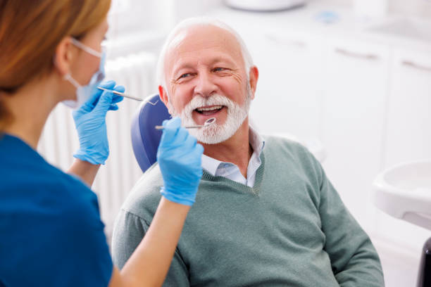 Senior man having dental checkup stock photo