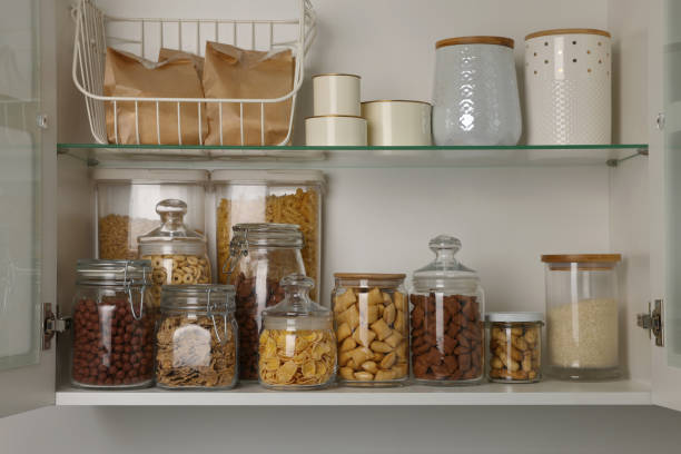 istock Glass containers with different breakfast cereals and other products on shelves 1457058266