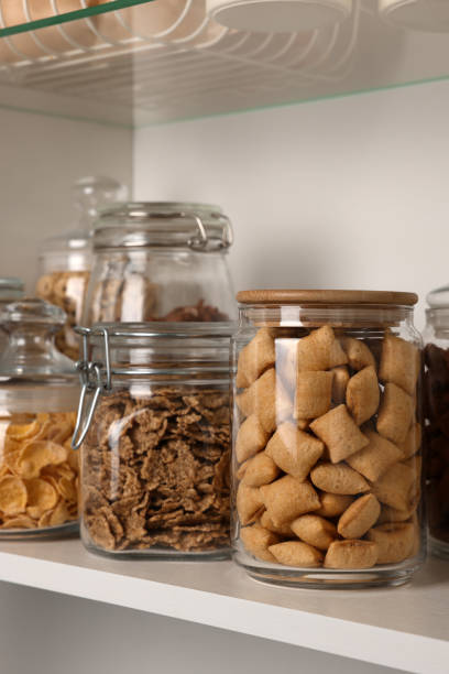 istock Glass containers with different breakfast cereals on shelf 1457058612