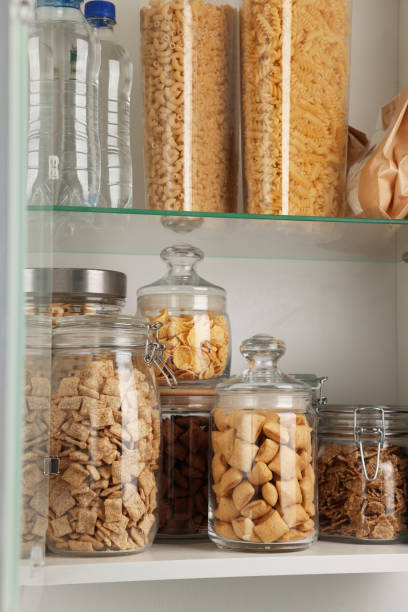 istock Glass containers with different breakfast cereals and other products on shelves 1457058613