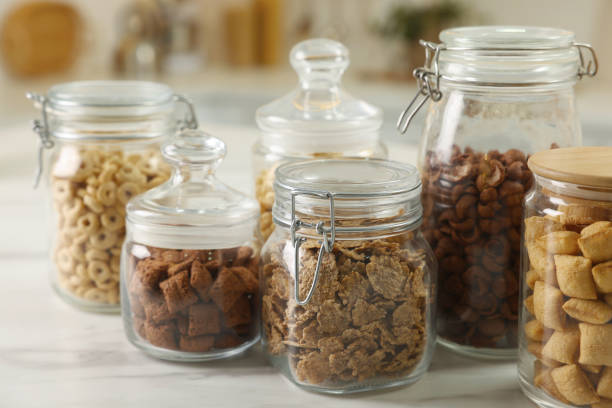 istock Glass containers with different breakfast cereals on white marble table indoors 1457058679