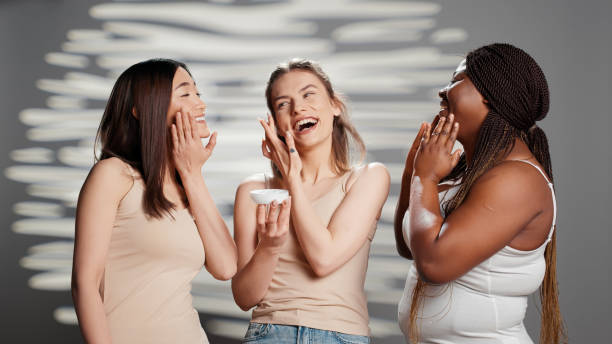 istock Group of flawless ladies applying moisturizing face cream 1457059611