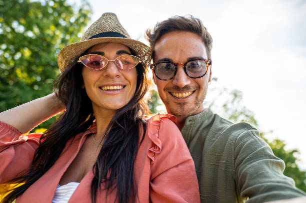 istock Young lovers selfie outdoor, backlight and nature background 1457060351